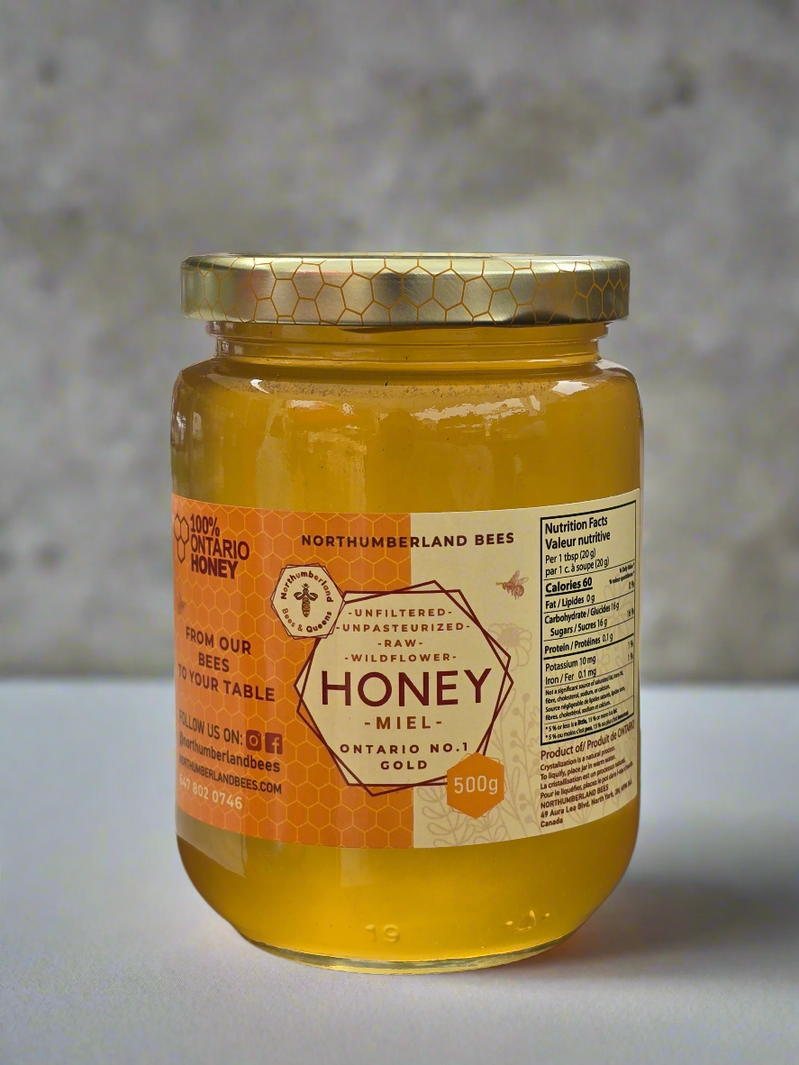Jar of honey with a label on a neutral background