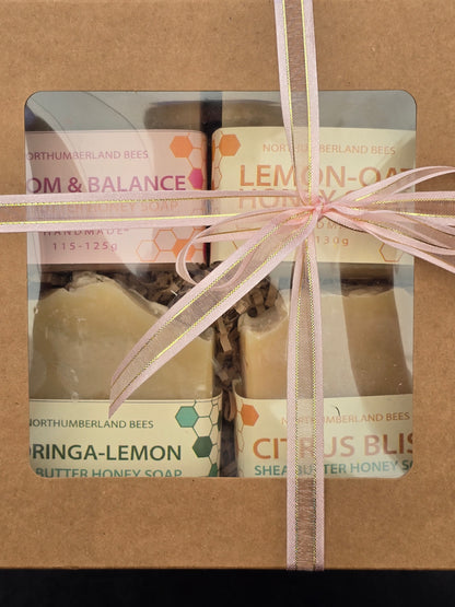 Gift set of soap bars in a brown box with a pink ribbon